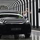 Tesla CEO Elon Musk looks at a new Model 3. The company was just removed from the S&P 500 ESG Index.